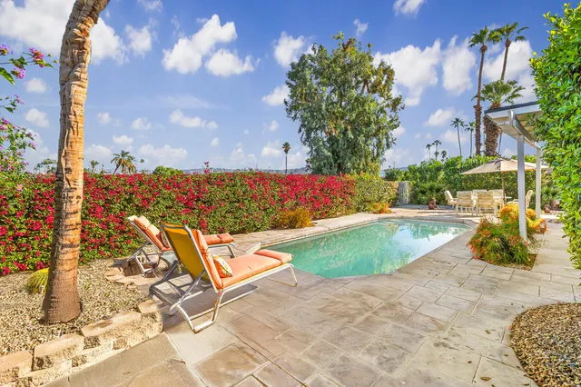 a view of a swimming pool with a lounge chairs