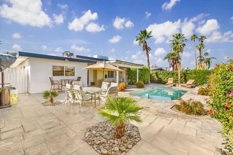 a view of a patio with table and chairs and potted plants