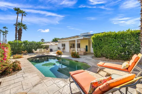 a view of a backyard with sitting area
