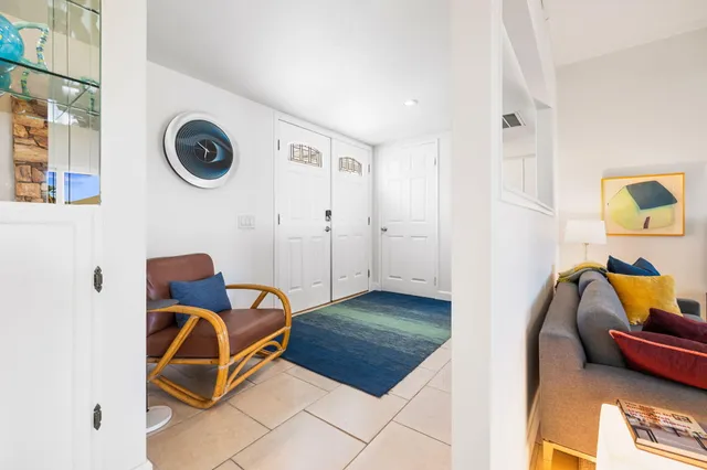 a living room with furniture and a clock