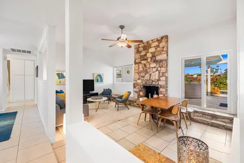 a living room with furniture a fireplace and a table