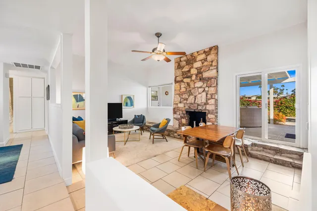a living room with furniture a fireplace and a table
