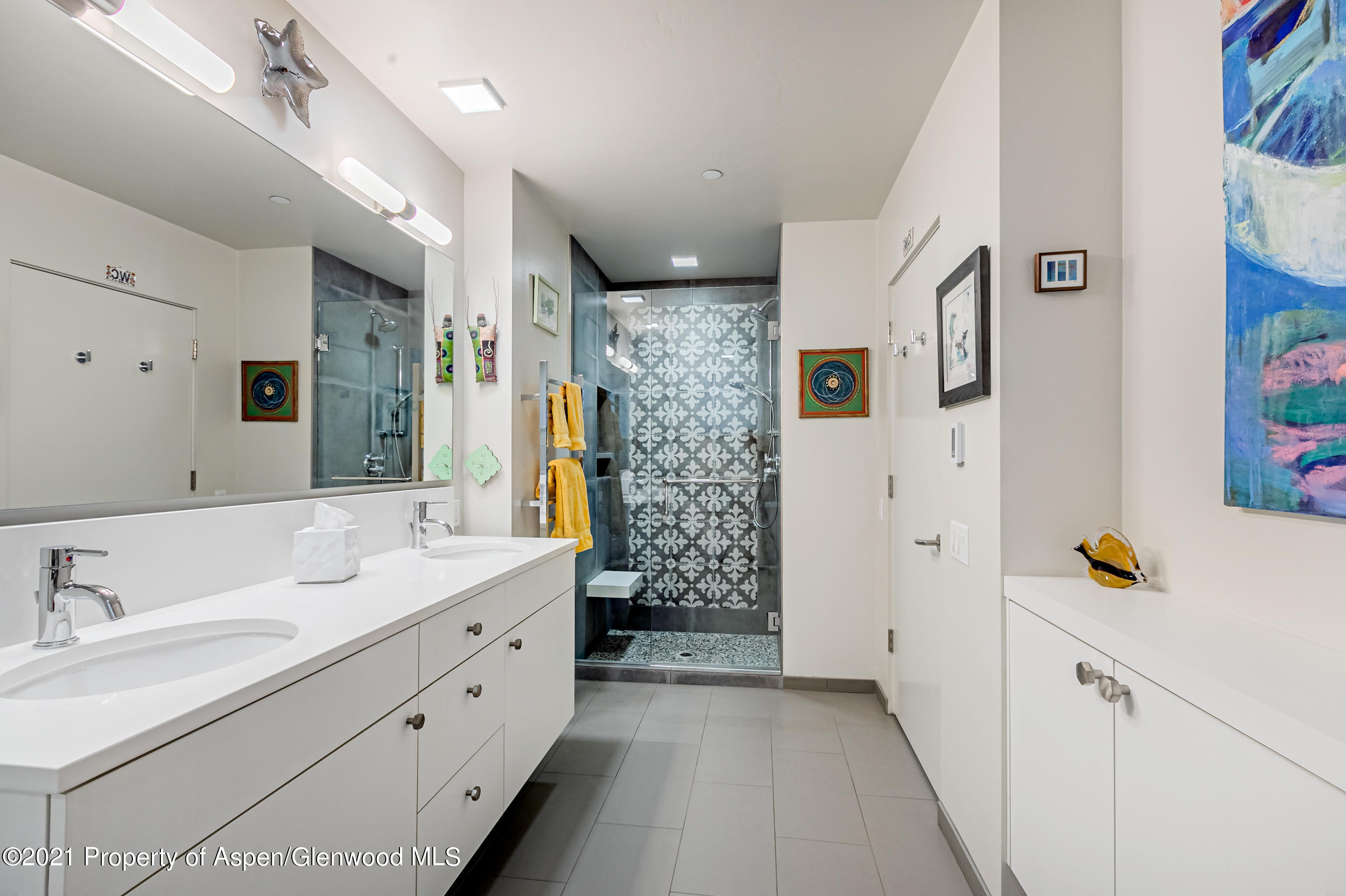 104 Evans Road, Unit 108 Basalt, CO 81621 - Photo 15 of 20 a spacious bathroom with a double vanity sink a mirror a shower and a bathtub