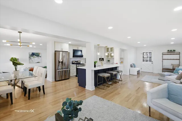 a living room with furniture and kitchen view
