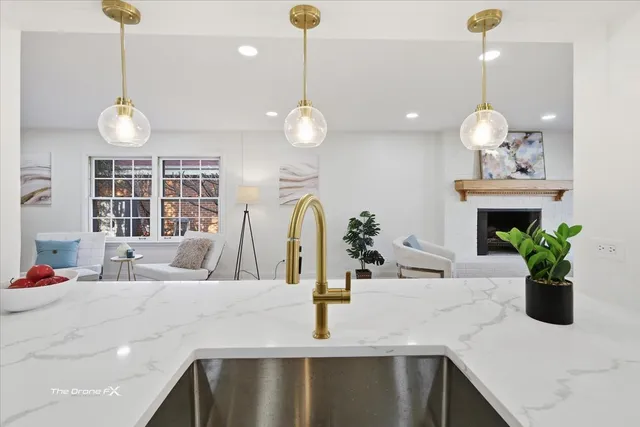 a kitchen with a sink and chandelier