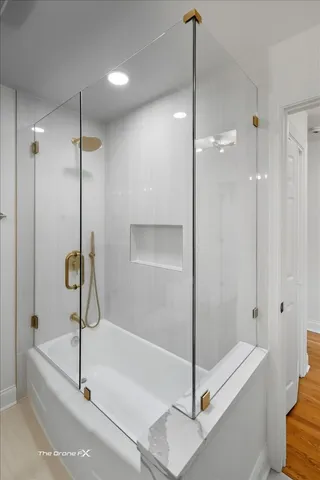 a bathroom with a tub and a shower