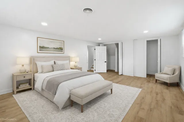 a spacious bedroom with a bed and a couch