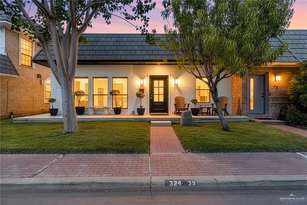 a view of yard with tree in front of it