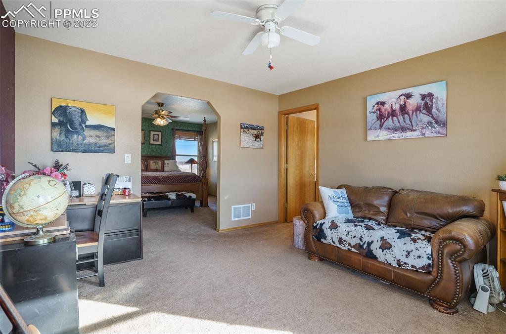10695 Walker Road Colorado Springs, CO 80908 - Photo 13 of 49 a living room with furniture and a chandelier