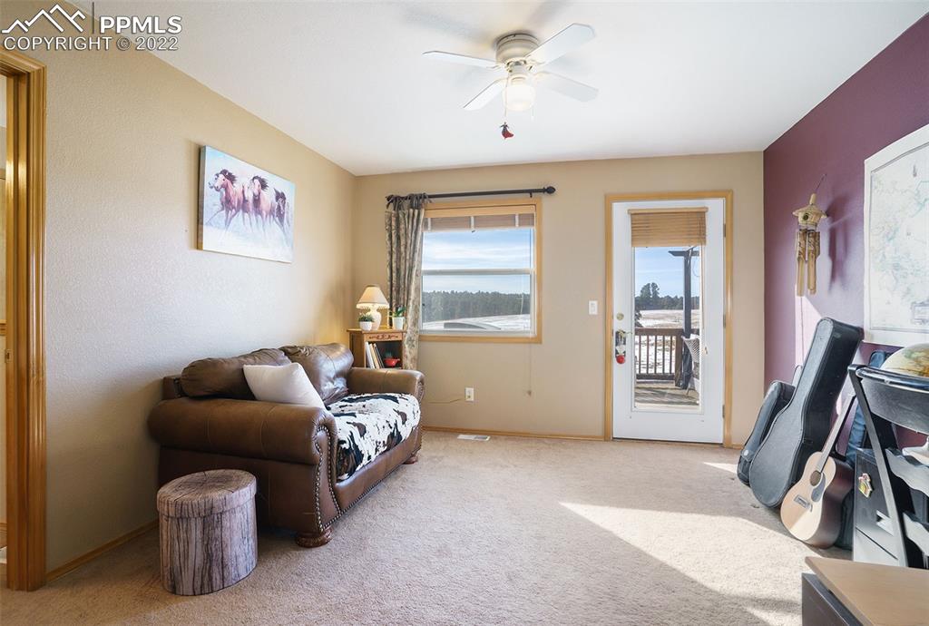 10695 Walker Road Colorado Springs, CO 80908 - Photo 14 of 49 a bedroom with a bed and a couch