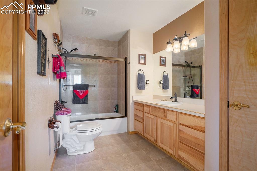 10695 Walker Road Colorado Springs, CO 80908 - Photo 20 of 49 a bathroom with a sink toilet and shower