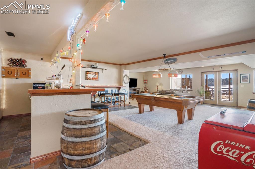 10695 Walker Road Colorado Springs, CO 80908 - Photo 22 of 49 a room with view of counter and chairs