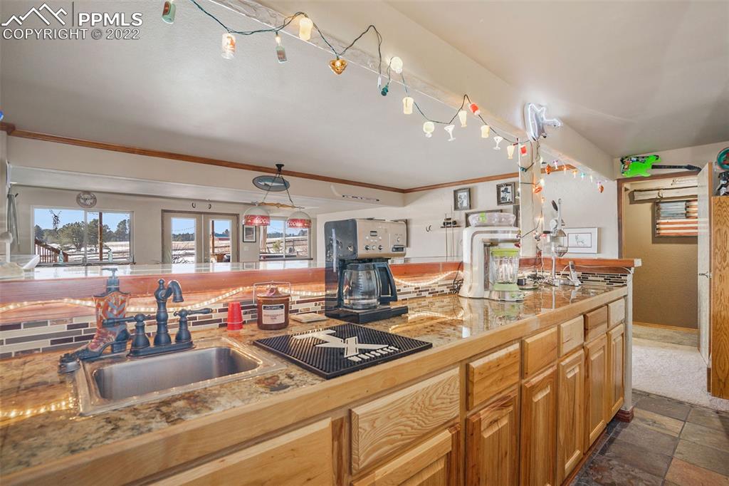 10695 Walker Road Colorado Springs, CO 80908 - Photo 23 of 49 a large kitchen with lots of counter top space