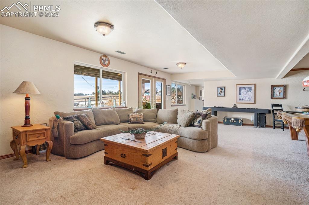 10695 Walker Road Colorado Springs, CO 80908 - Photo 26 of 49 a living room with furniture and a large window