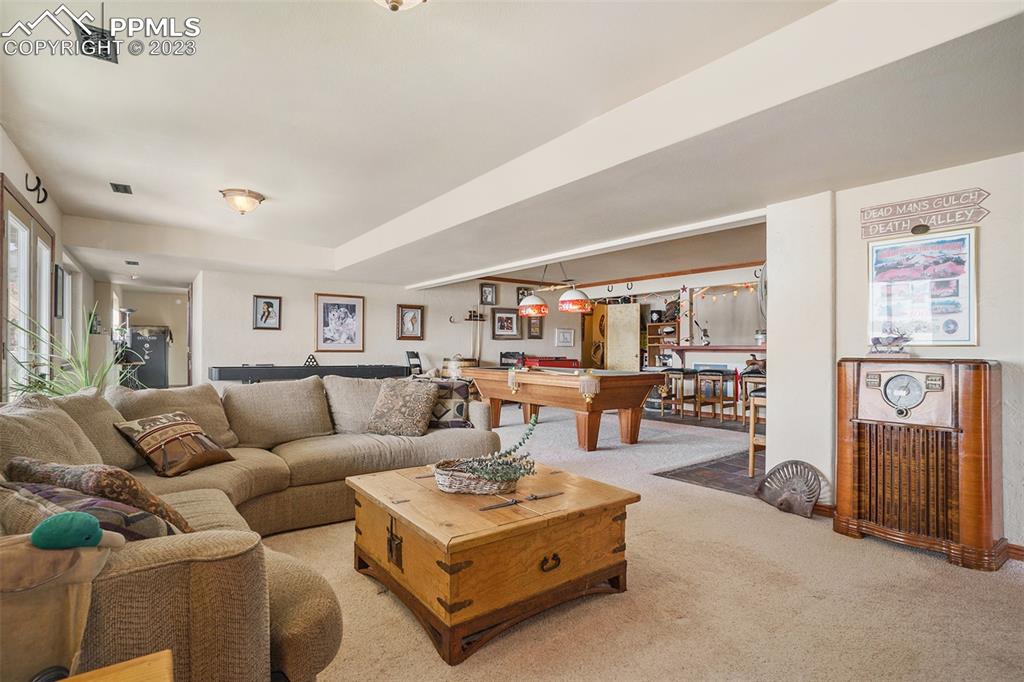 10695 Walker Road Colorado Springs, CO 80908 - Photo 27 of 49 a living room with furniture and a table
