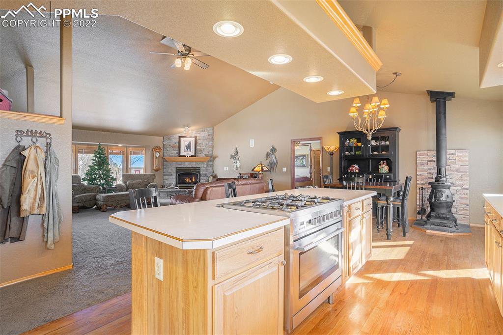 10695 Walker Road Colorado Springs, CO 80908 - Photo 3 of 49 a open kitchen with stainless steel appliances granite countertop a stove oven and a refrigerator with the cabinets