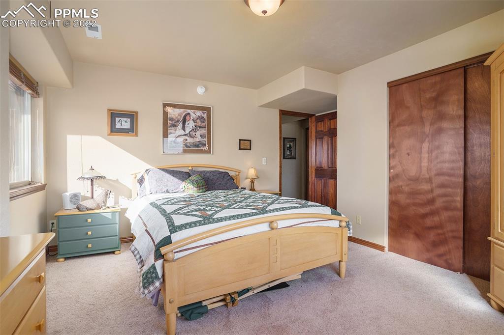 10695 Walker Road Colorado Springs, CO 80908 - Photo 33 of 49 a bedroom with a bed and a cabinets