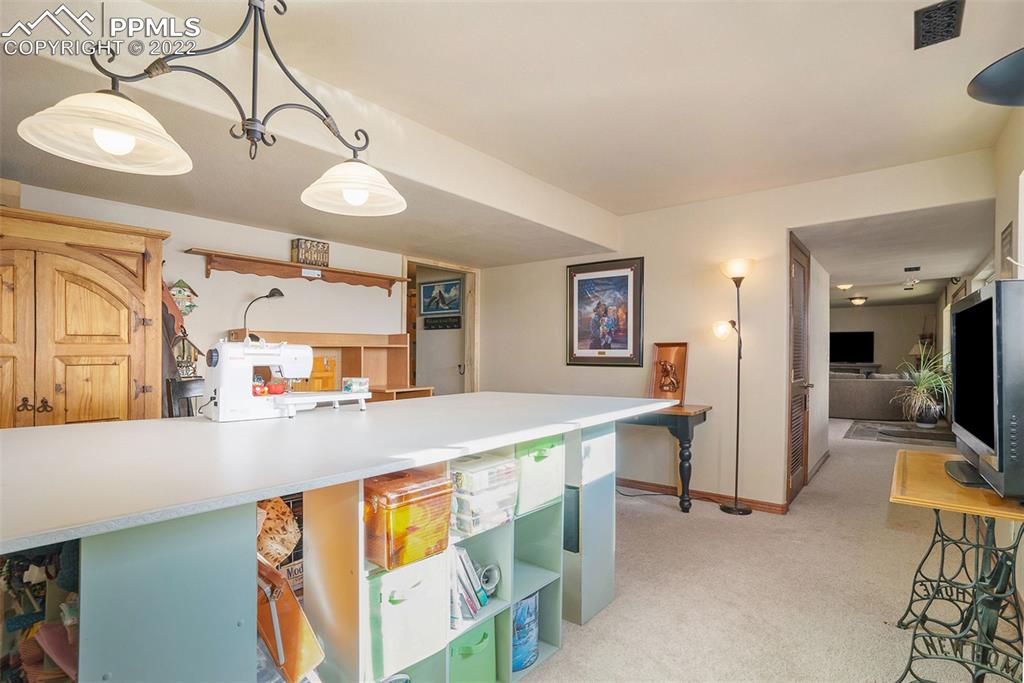 10695 Walker Road Colorado Springs, CO 80908 - Photo 35 of 49 a kitchen with stainless steel appliances a stove a sink cabinets and a dining table