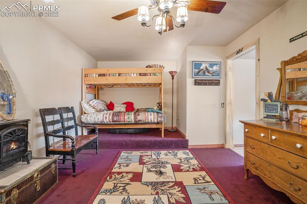 10695 Walker Road Colorado Springs, CO 80908 - Photo 37 of 49 a living room with furniture and a dresser