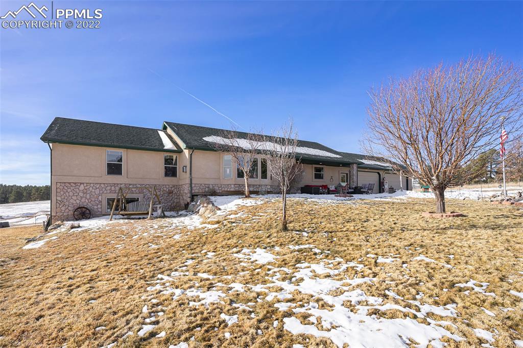 10695 Walker Road Colorado Springs, CO 80908 - Photo 38 of 49 a front view of a house with a yard covered in snow