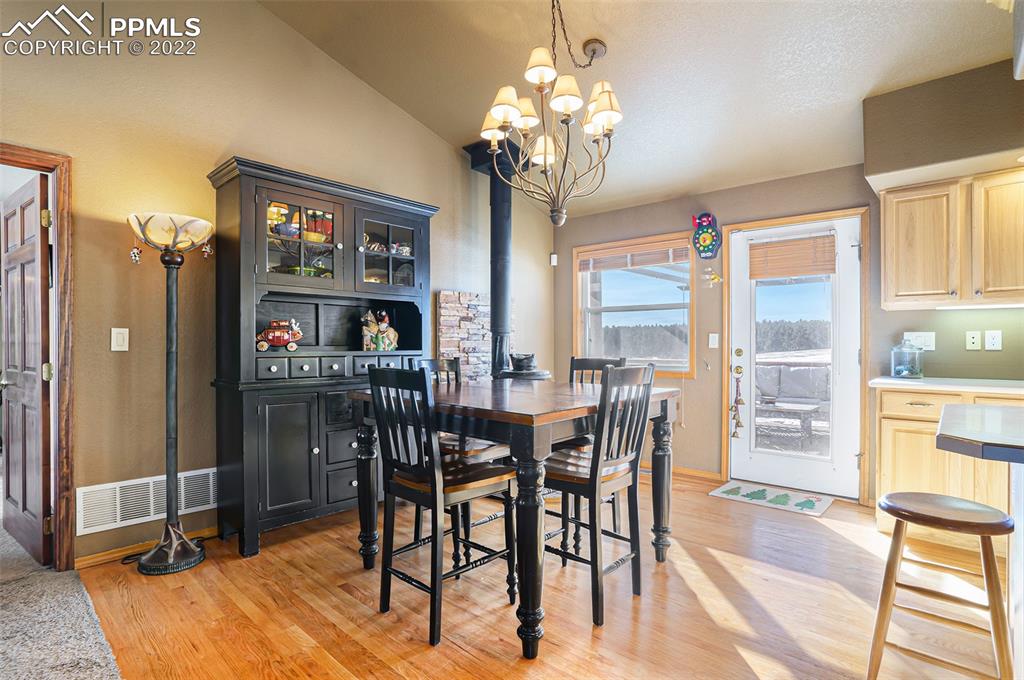 10695 Walker Road Colorado Springs, CO 80908 - Photo 6 of 49 a view of a dining room with furniture and a chandelier