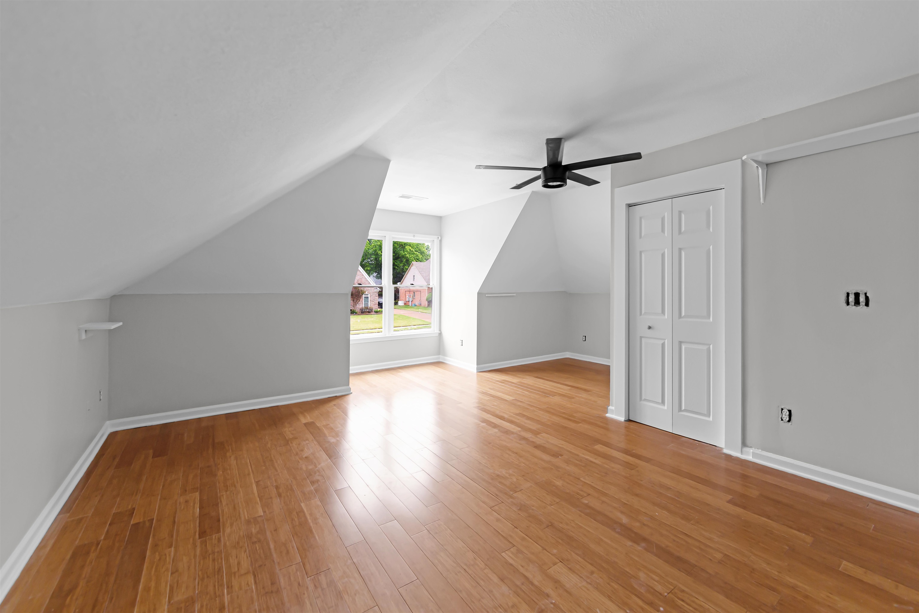 1331 Wahkin Road Collierville, TN 38017 - Photo 22 of 25 a view of an empty room with wooden floor and a ceiling fan