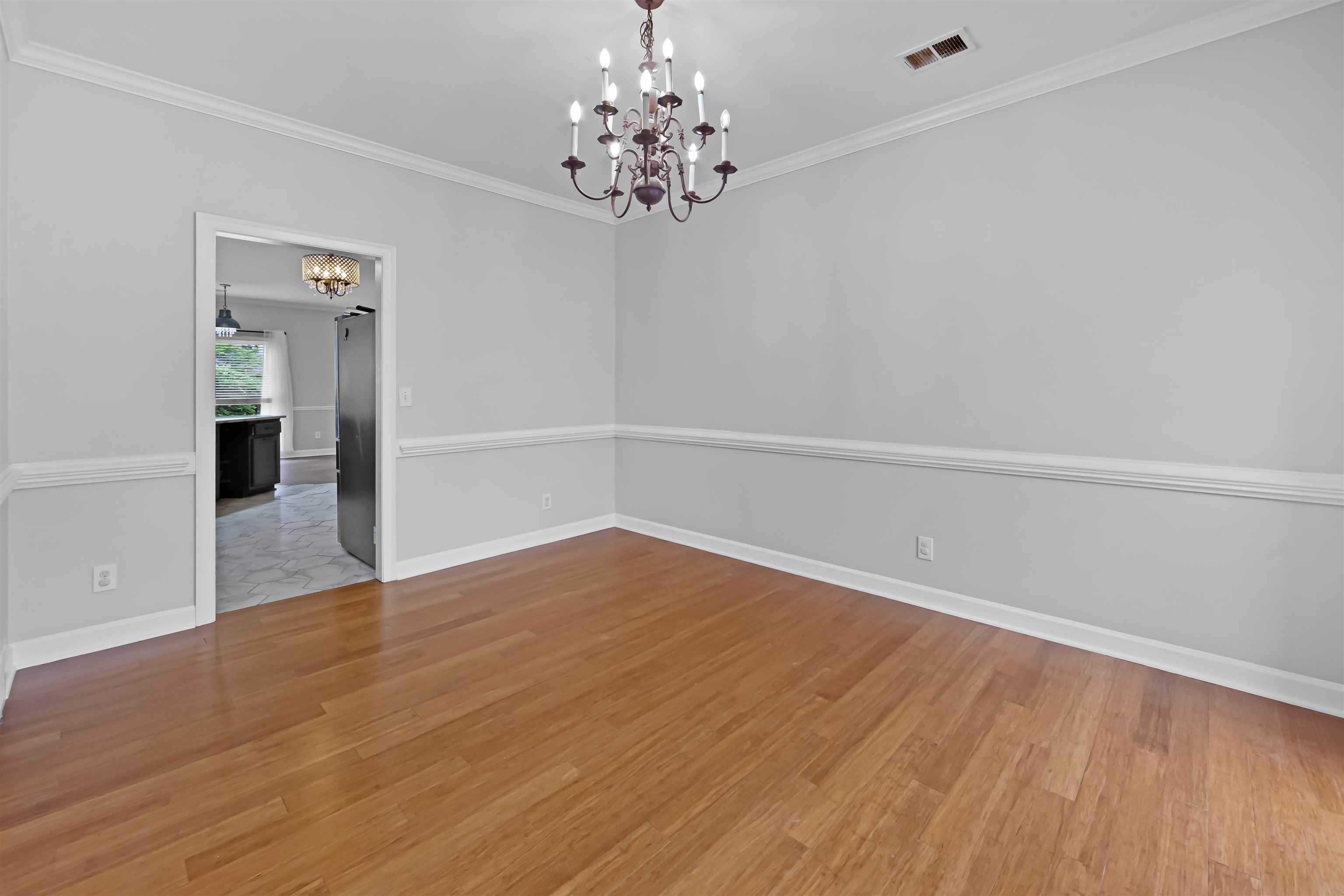 1331 Wahkin Road Collierville, TN 38017 - Photo 5 of 25 wooden floor in an empty room with a window