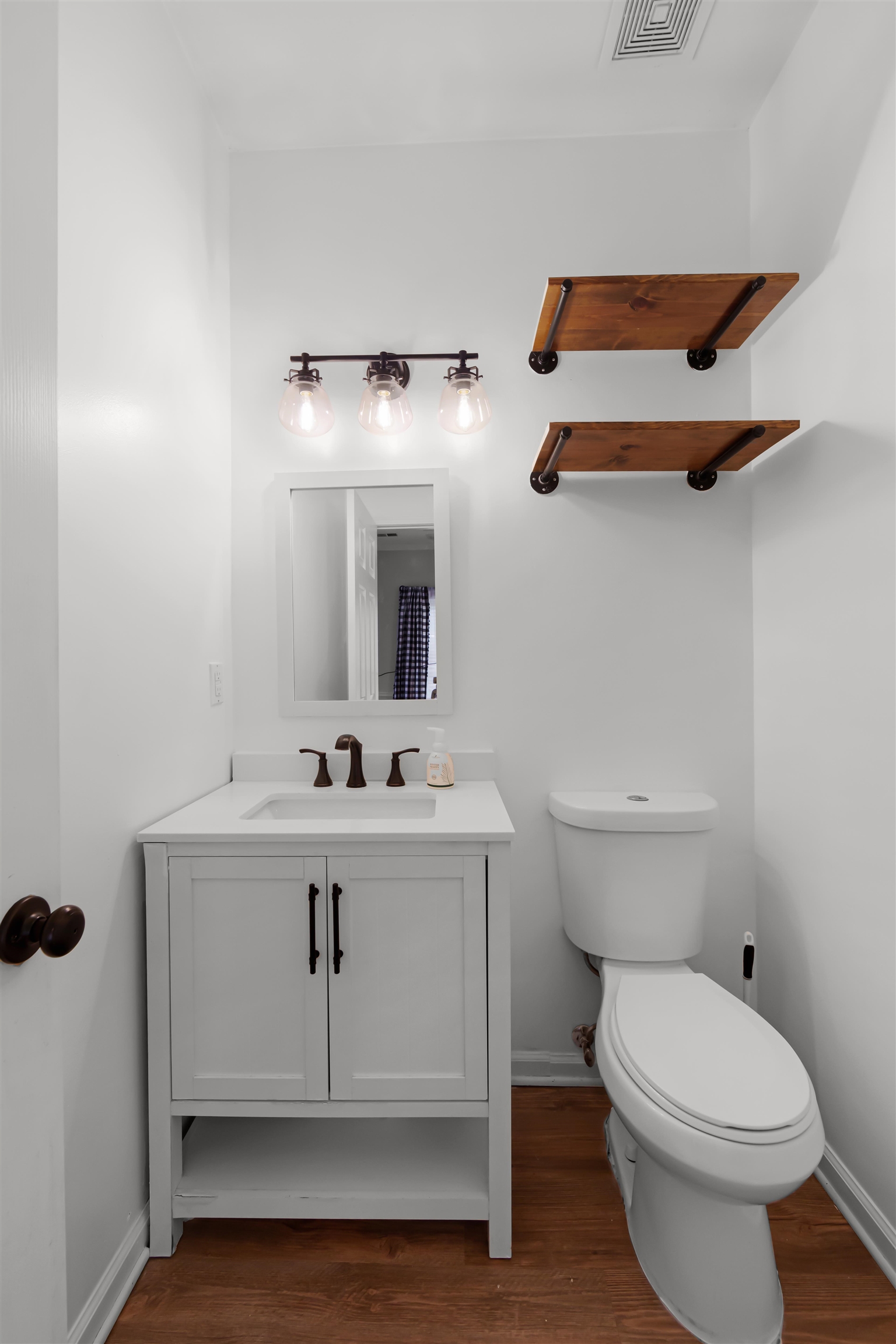 1331 Wahkin Road Collierville, TN 38017 - Photo 7 of 25 a bathroom with a sink a toilet and mirror