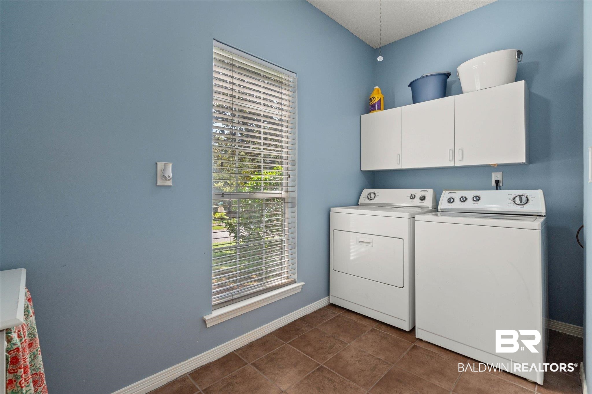 1640 Aden Road Mobile, AL 36695 - Photo 15 of 20 Washroom with washer and clothes dryer, cabinet space, and dark tile patterned flooring
