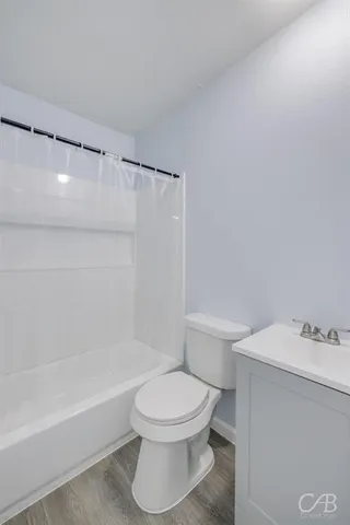 a white toilet sitting next to a bath tub