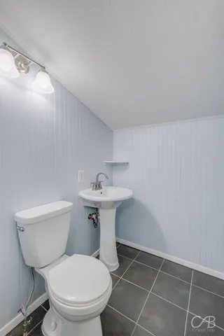 a bathroom with a sink toilet and a mirror