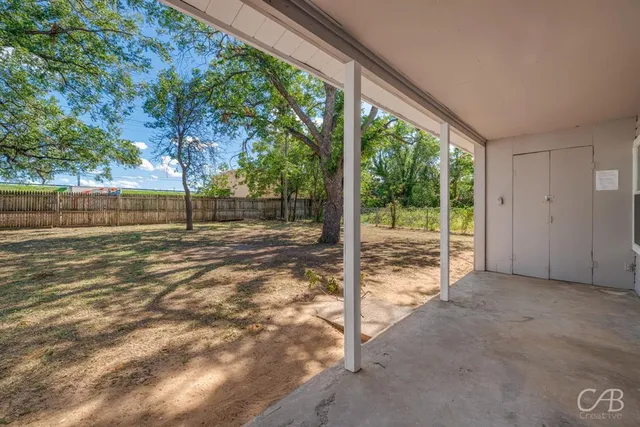 a view of a house with yard and a tree