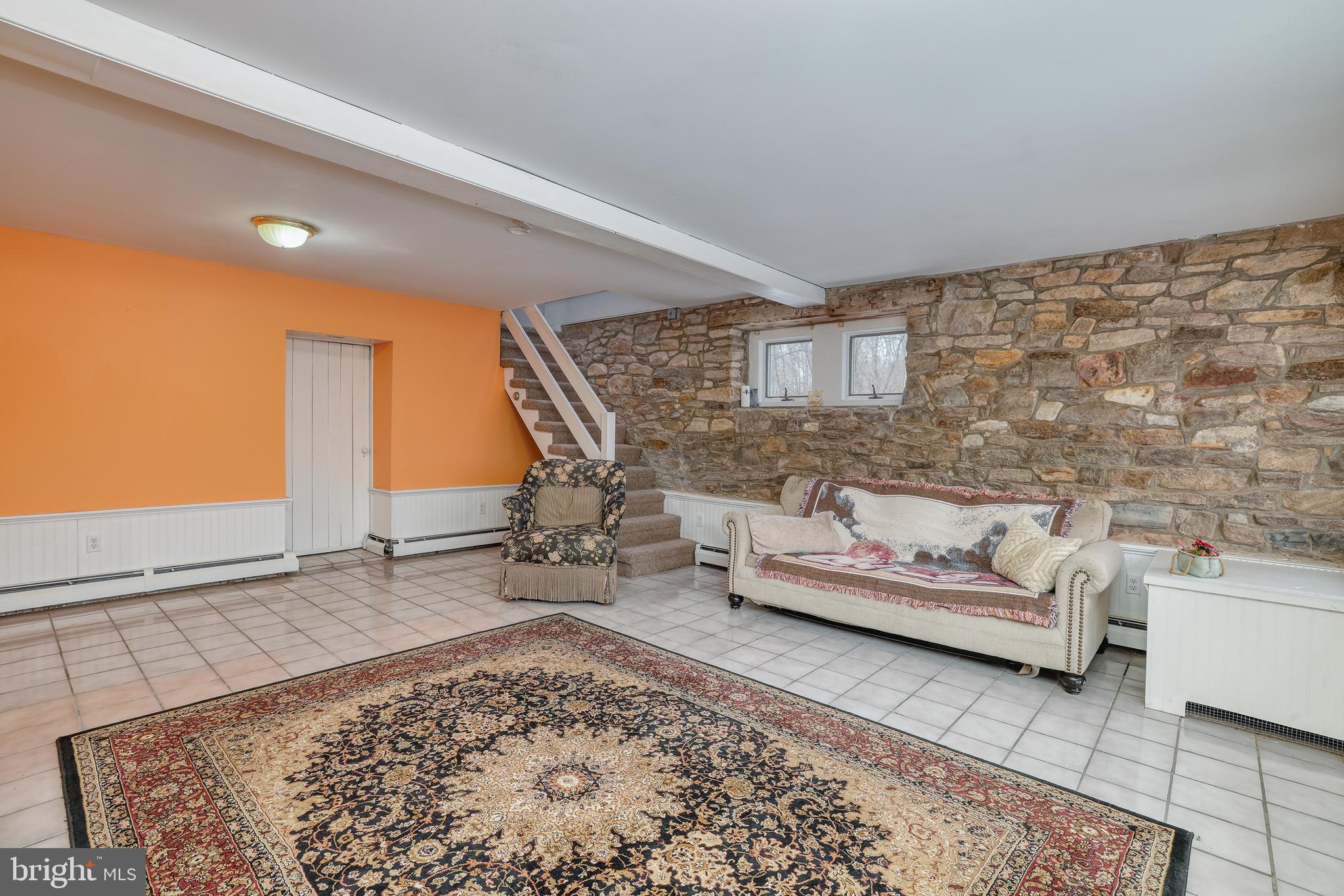 5496 York Rd., Unit CARRIAGE Doylestown, PA 18902 - Photo 32 of 34 Spacious Finished Basement Featuring Stone Wall