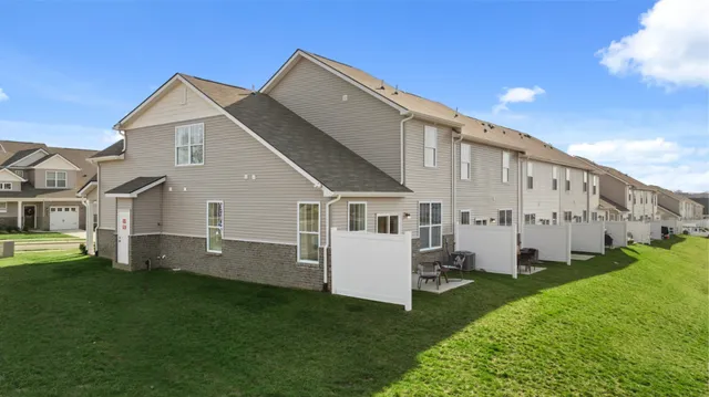a front view of a house with a garden and yard