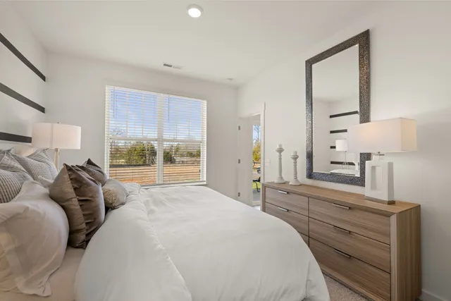 a bed room with a bed and a night stand