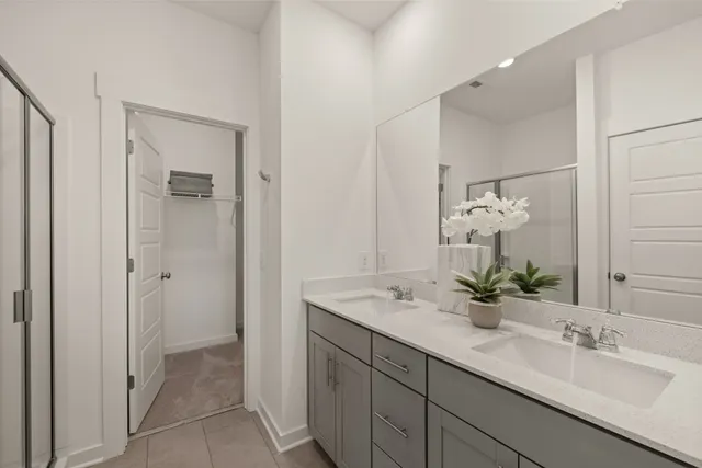 a bathroom with a double vanity sink and mirror