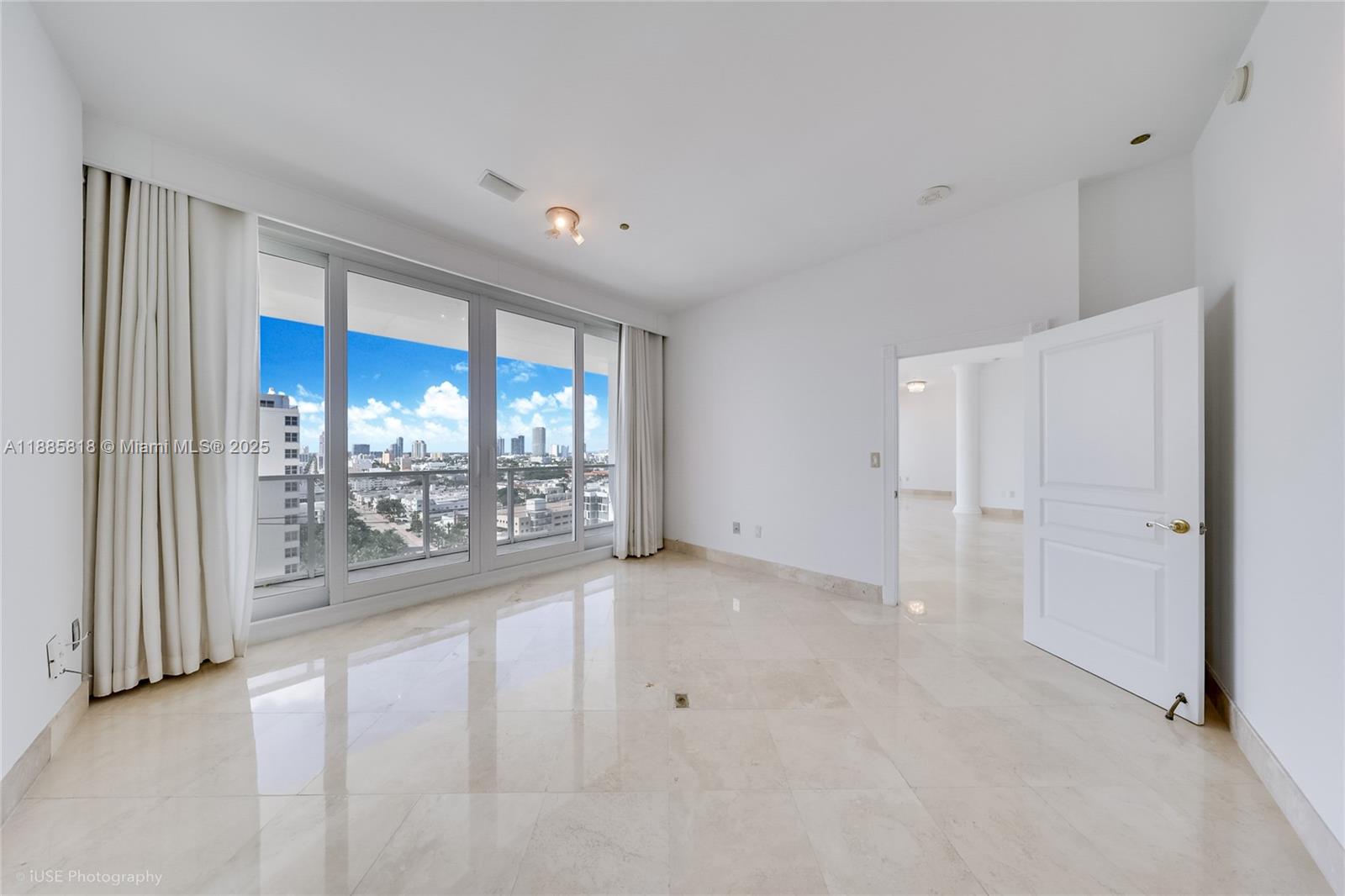 100 Lincoln Road, Unit PH12 Miami Beach, FL 33139 - Photo 13 of 41 a view of a big room with windows and chandelier fan