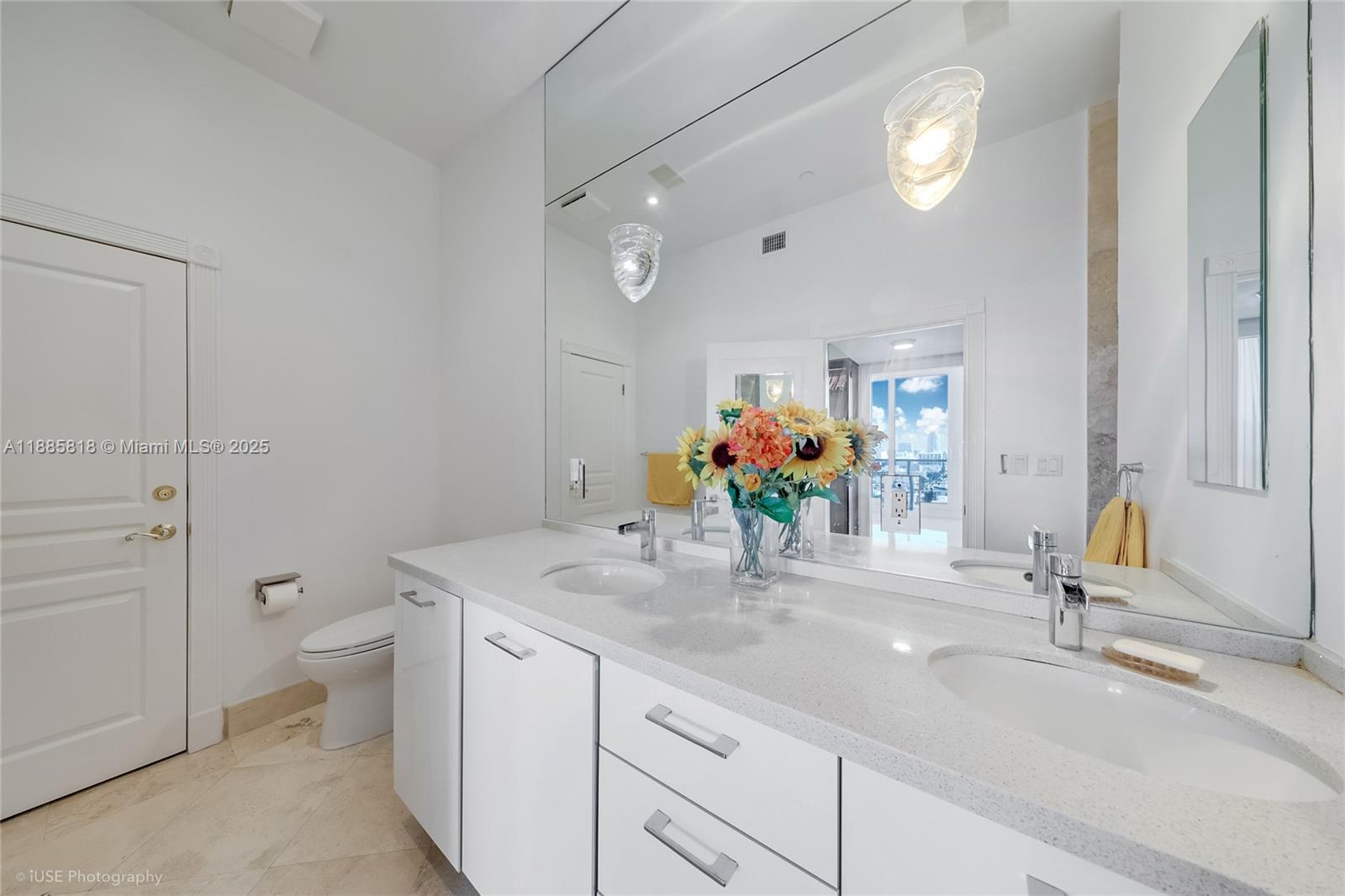 100 Lincoln Road, Unit PH12 Miami Beach, FL 33139 - Photo 15 of 41 a bathroom with a sink a toilet and mirror