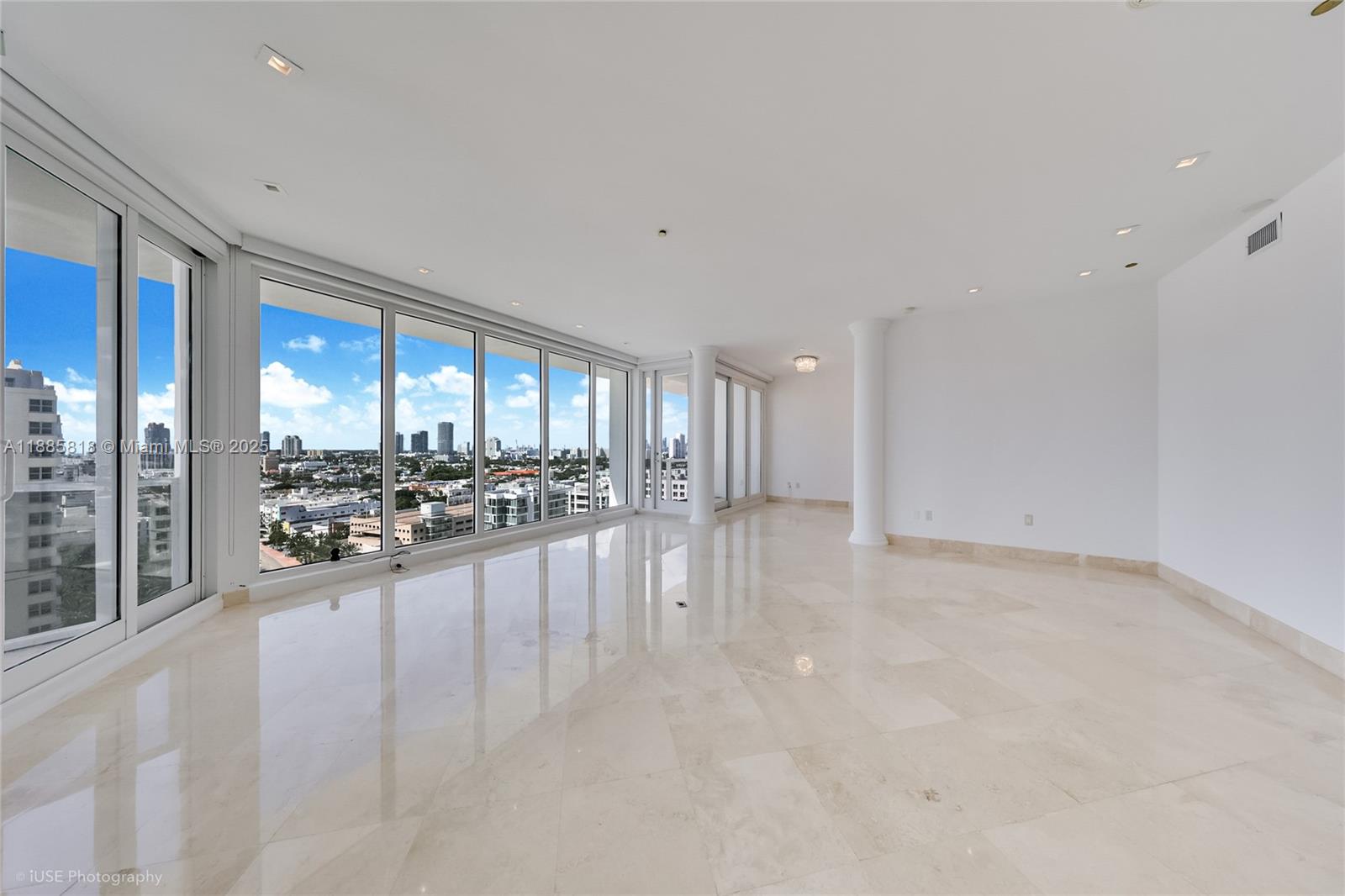 100 Lincoln Road, Unit PH12 Miami Beach, FL 33139 - Photo 2 of 41 a view of an empty room with a floor to ceiling window and couch