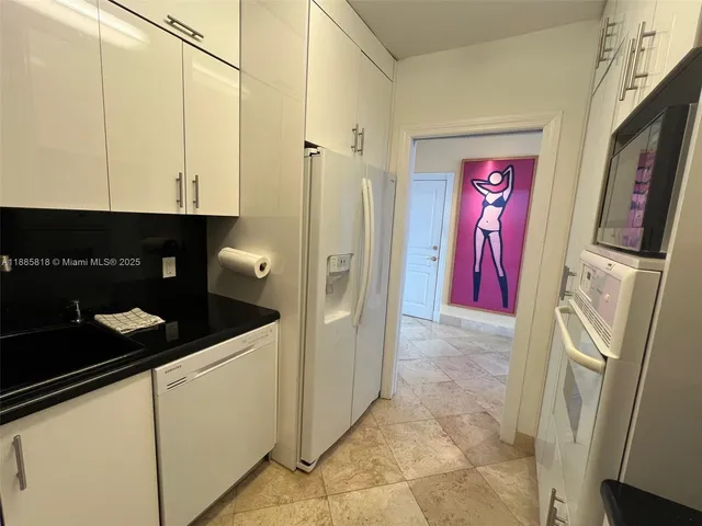 a view of a kitchen with a washer and dryer