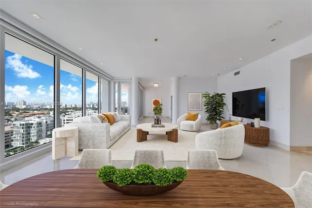 a living room with furniture a flat screen tv and a large window