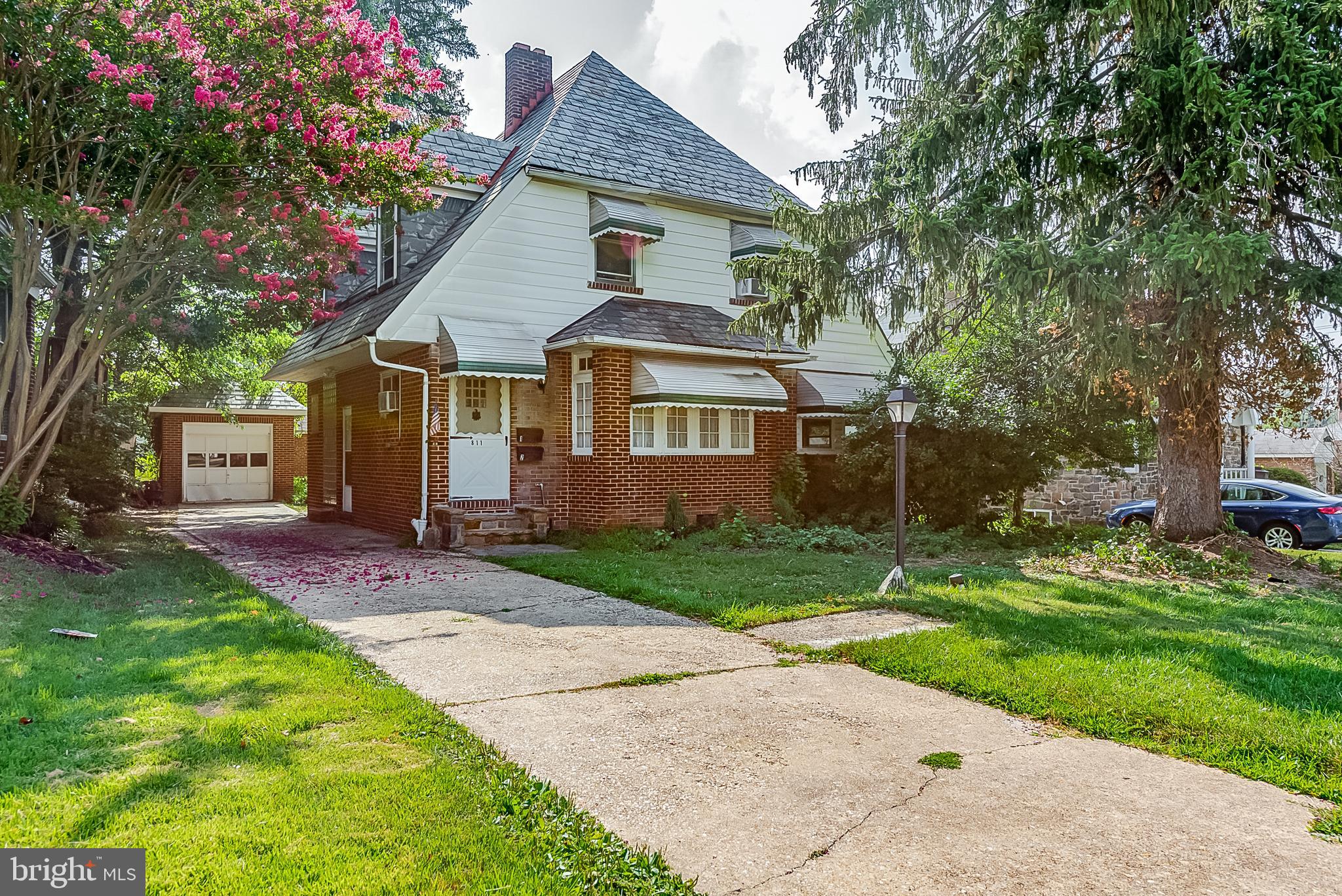 811 Dorchester Road Baltimore, MD 21229 - Photo 1 of 45 a front view of a house with a garden and trees