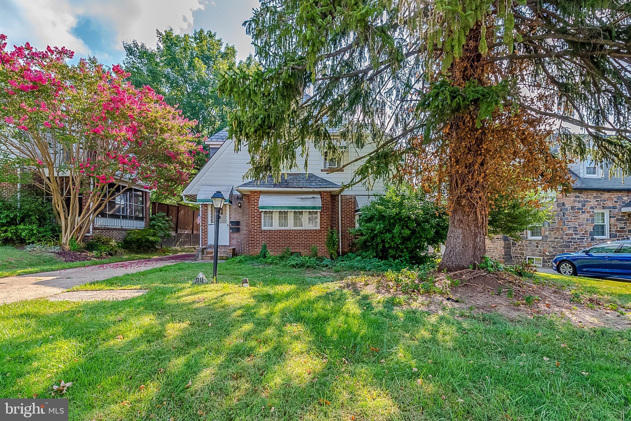 811 Dorchester Road Baltimore, MD 21229 - Photo 2 of 45 a view of a house with a big yard and large trees