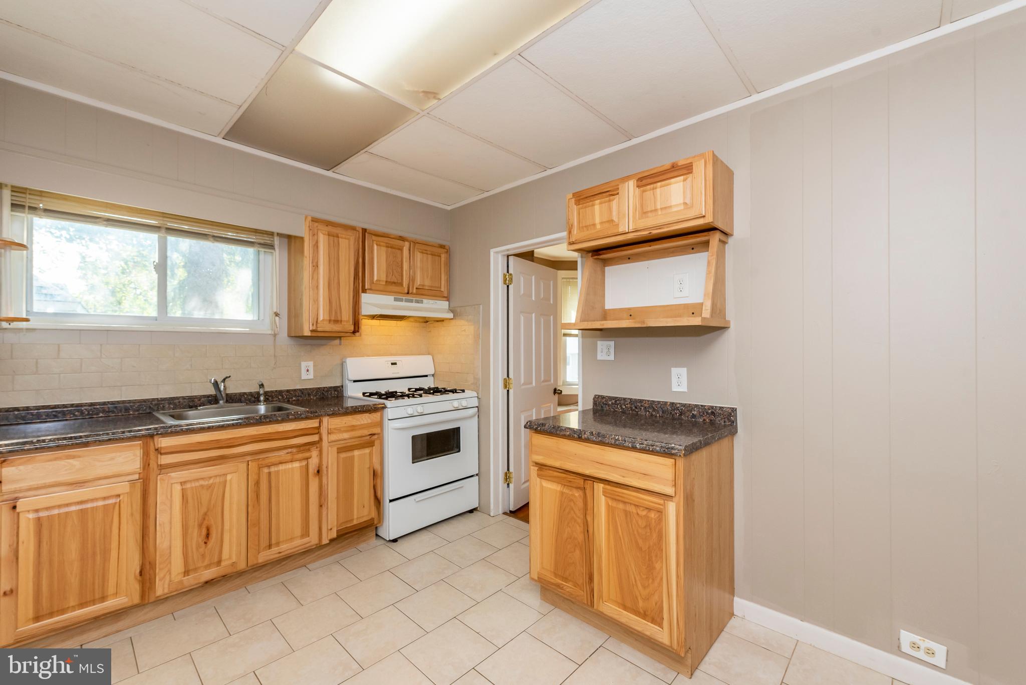811 Dorchester Road Baltimore, MD 21229 - Photo 12 of 45 a kitchen with a stove a sink and a refrigerator