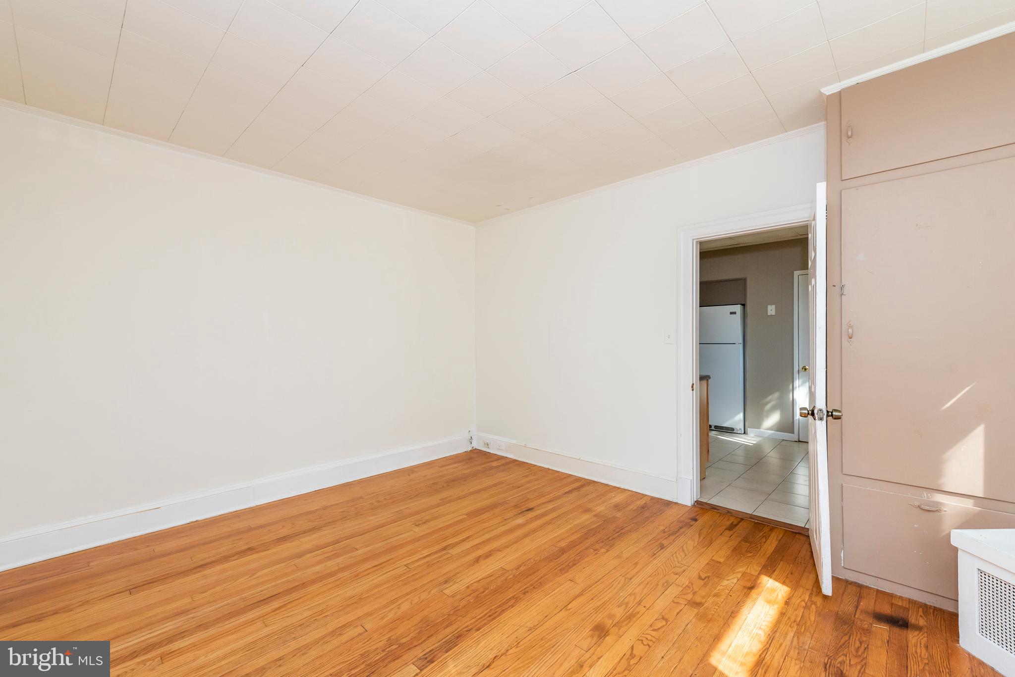 811 Dorchester Road Baltimore, MD 21229 - Photo 17 of 45 a view of empty room with wooden floor