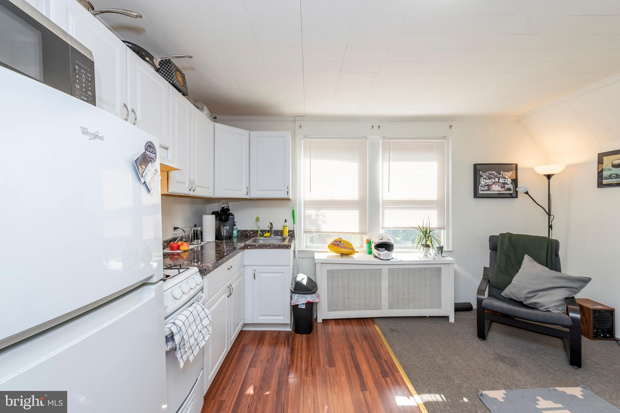 811 Dorchester Road Baltimore, MD 21229 - Photo 25 of 45 a kitchen with a sink a stove a refrigerator and a window