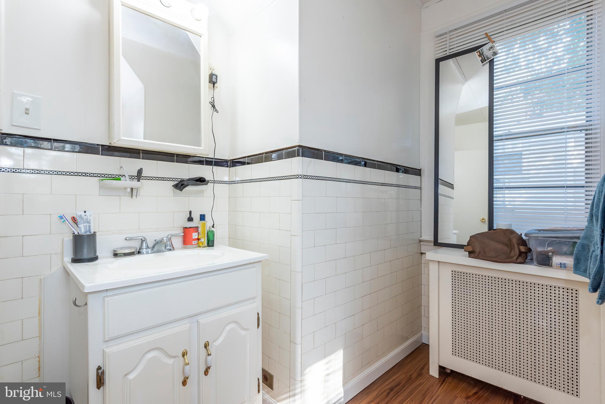 811 Dorchester Road Baltimore, MD 21229 - Photo 32 of 45 a bathroom with a sink and a mirror