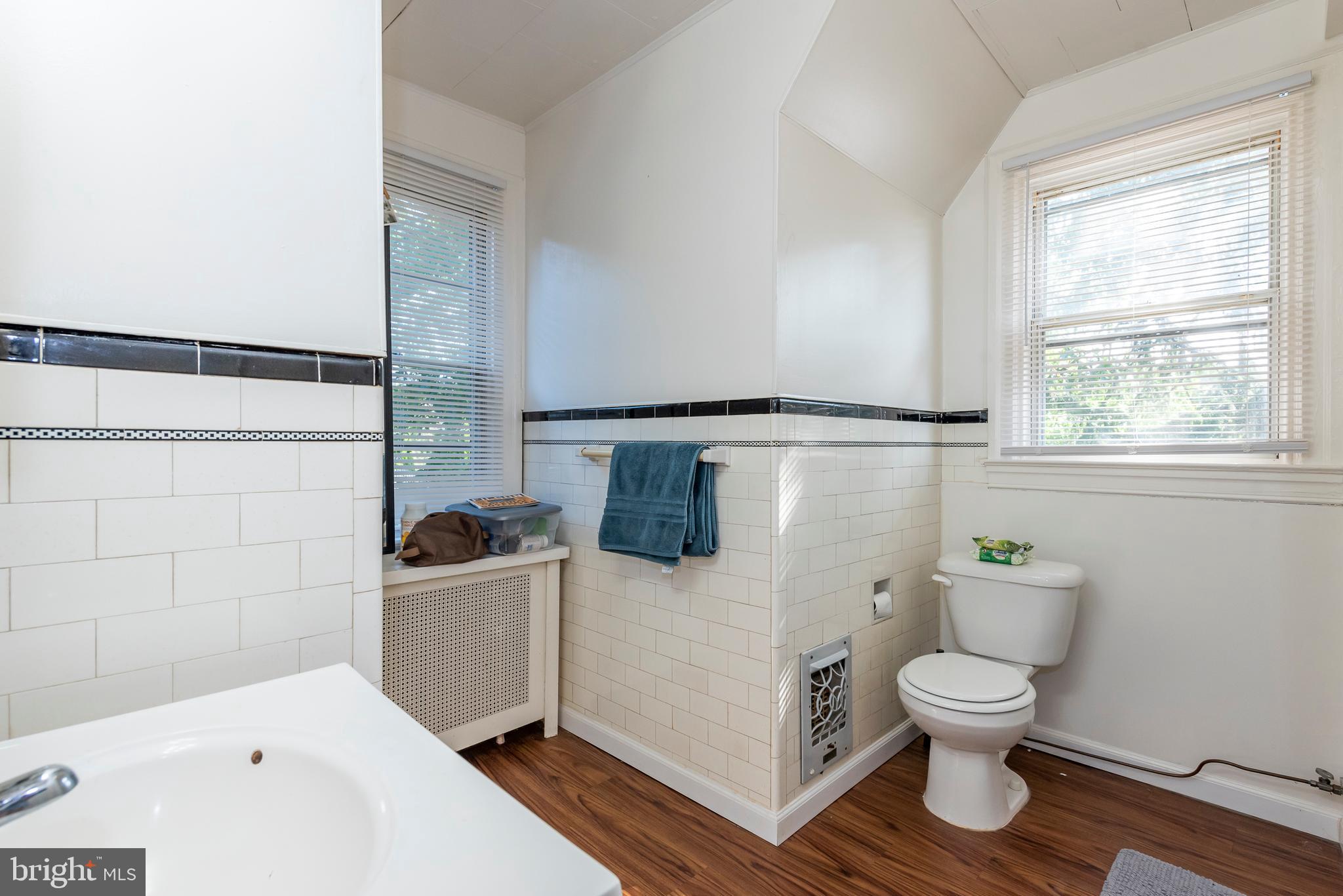 811 Dorchester Road Baltimore, MD 21229 - Photo 33 of 45 a bathroom with a sink a toilet and shower