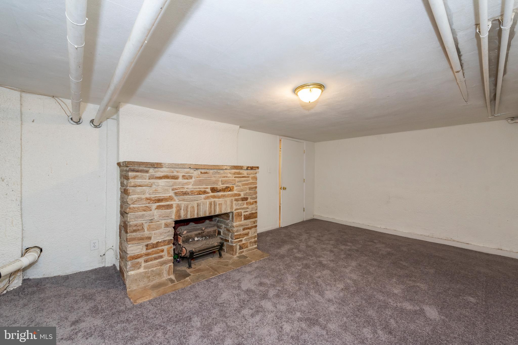 811 Dorchester Road Baltimore, MD 21229 - Photo 37 of 45 a view of an empty room with a fireplace