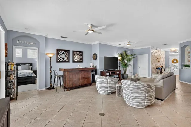 a kitchen with stainless steel appliances kitchen island granite countertop a table chairs and a refrigerator
